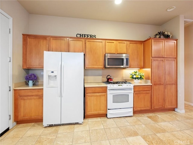 kitchen with recessed lighting, white appliances, brown cabinetry, light countertops, and baseboards