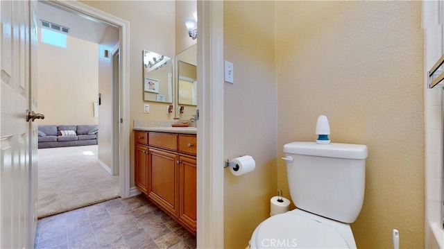 8846 Tamarisk Ave, Hesperia, CA 92344 - bathroom featuring toilet, vanity, and stone finish floors
