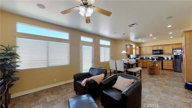 8846 Tamarisk Ave, Hesperia, CA 92344 - living room featuring baseboards, a ceiling fan, stone finish floors, and recessed lighting