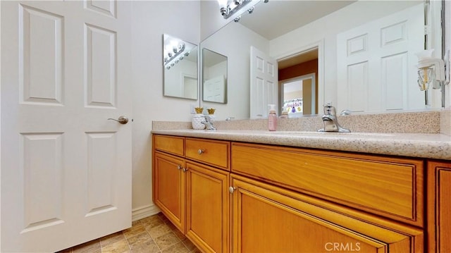 8846 Tamarisk Ave, Hesperia, CA 92344 - bathroom featuring double vanity and baseboards