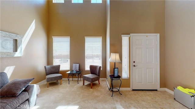 8846 Tamarisk Ave, Hesperia, CA 92344 - living area featuring a high ceiling and baseboards