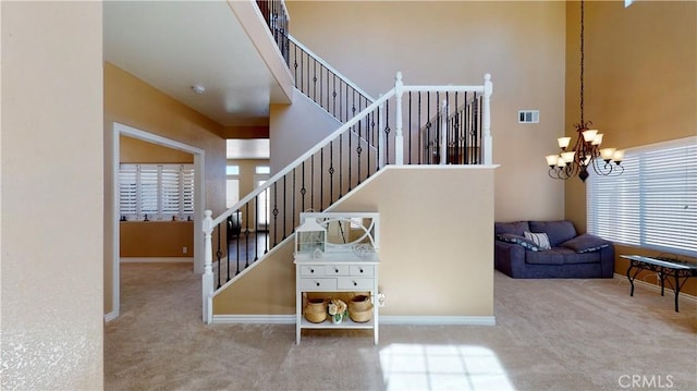8846 Tamarisk Ave, Hesperia, CA 92344 - staircase with carpet floors, a chandelier, a high ceiling, and baseboards