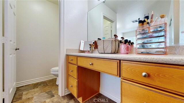 8846 Tamarisk Ave, Hesperia, CA 92344 - bathroom with toilet, vanity, and baseboards