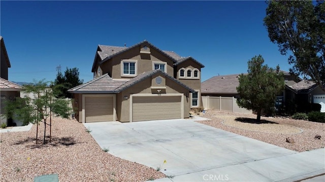 8846 Tamarisk Ave, Hesperia, CA 92344 - view of front of home featuring stucco siding, driveway, fence, a tile roof, and a garage