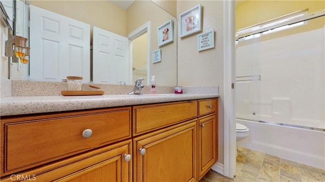 8846 Tamarisk Ave, Hesperia, CA 92344 - full bath with toilet, vanity, bath / shower combo with glass door, and stone finish flooring