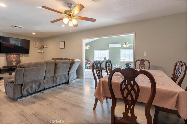 dining space with a wall mounted air conditioner, wood finished floors, recessed lighting, and ceiling fan