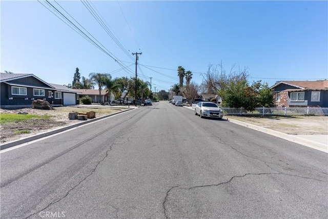 view of street featuring curbs and a residential view