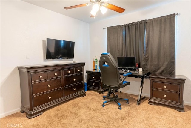 home office with baseboards, light colored carpet, and a ceiling fan