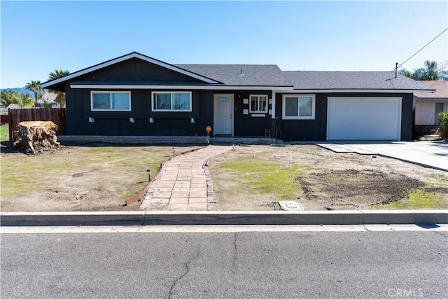 ranch-style house featuring fence, an attached garage, a shingled roof, concrete driveway, and board and batten siding