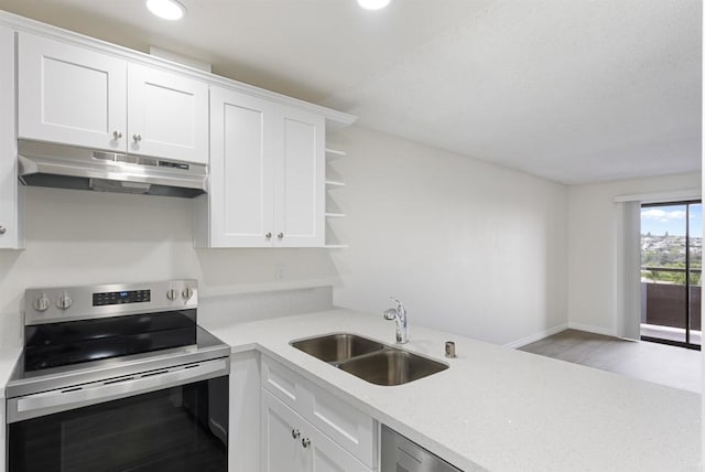 kitchen featuring stainless steel electric range oven, light countertops, under cabinet range hood, and a sink