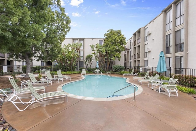 community pool featuring a patio area and fence