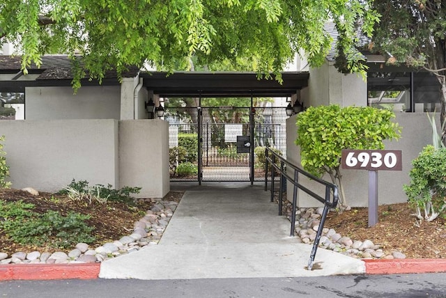 view of home's community featuring fence and a gate