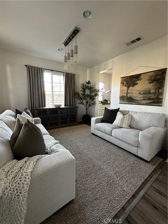 living room featuring visible vents, recessed lighting, and wood finished floors