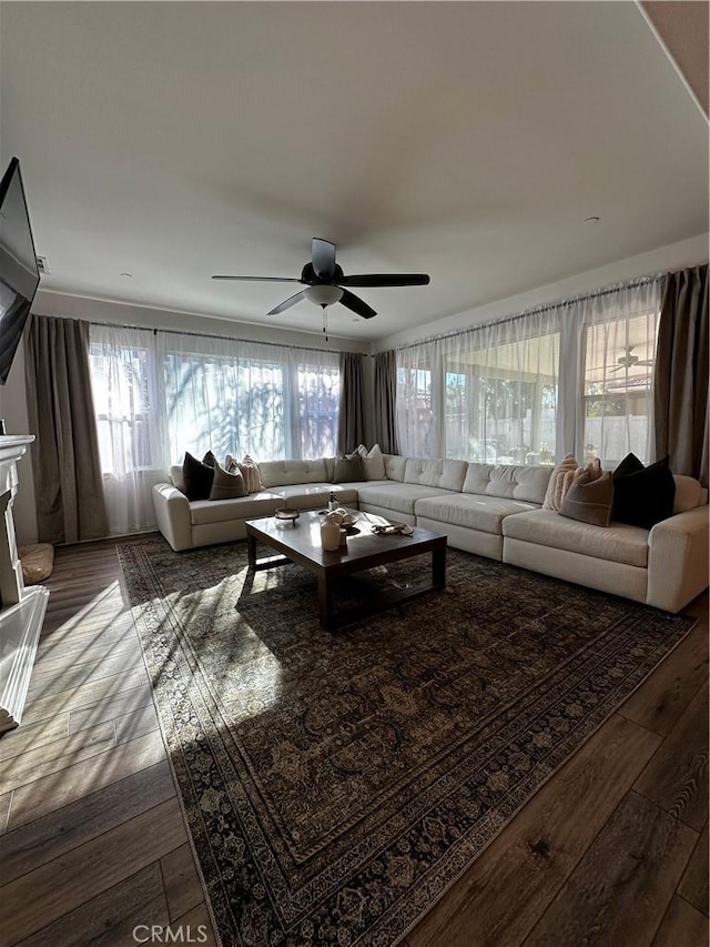 living area featuring hardwood / wood-style flooring and a ceiling fan