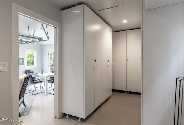 corridor featuring recessed lighting and concrete flooring