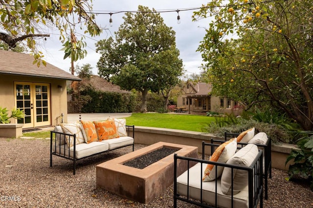 view of patio / terrace with french doors and an outdoor living space with a fire pit