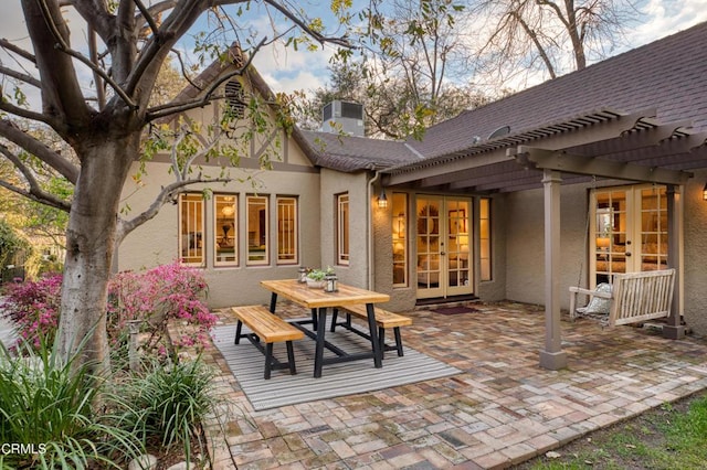 rear view of house featuring a patio, french doors, a pergola, and stucco siding