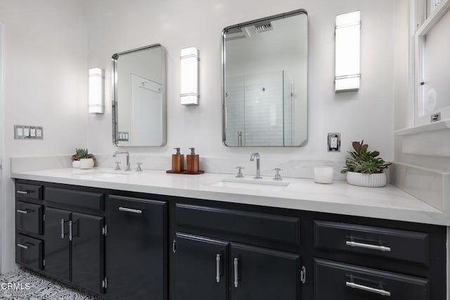 full bath with double vanity, a shower stall, and a sink