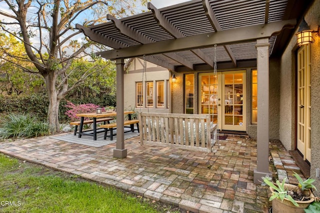 view of patio / terrace with outdoor dining area, french doors, and a pergola