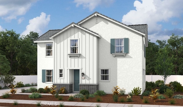 view of front of property featuring fence, board and batten siding, and stucco siding