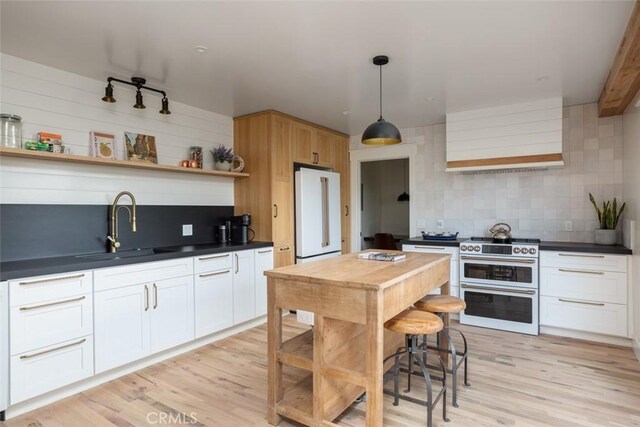 236 Avenida Montalvo, San Clemente, CA 92672 - kitchen featuring open shelves, white appliances, dark countertops, backsplash, and light wood-type flooring