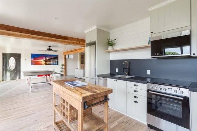 236 Avenida Montalvo, San Clemente, CA 92672 - kitchen with stainless steel appliances, open shelves, dark countertops, light wood-style floors, and beam ceiling