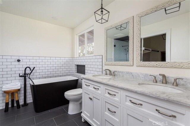 236 Avenida Montalvo, San Clemente, CA 92672 - full bath featuring tile walls, tile patterned floors, a freestanding bath, double vanity, and wainscoting