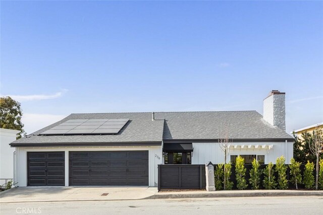 236 Avenida Montalvo, San Clemente, CA 92672 - modern farmhouse featuring roof mounted solar panels, a garage, concrete driveway, board and batten siding, and a chimney