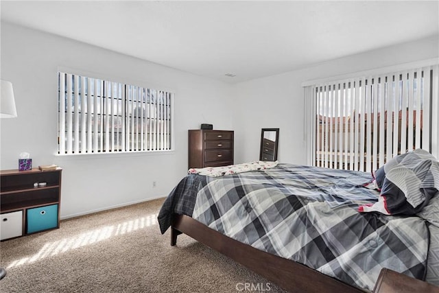 carpeted bedroom with baseboards