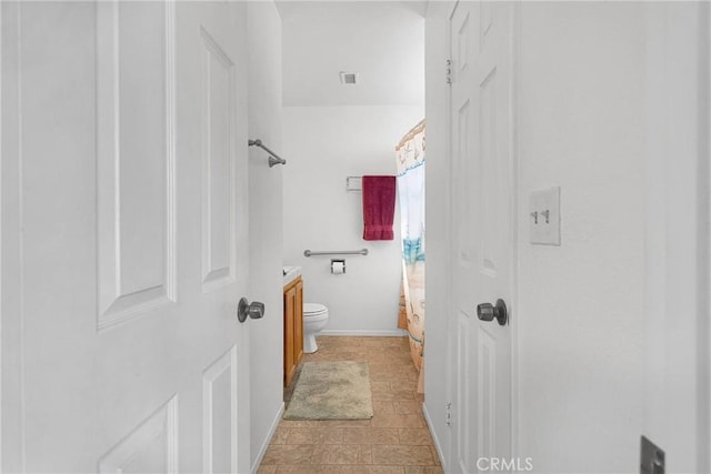 bathroom with vanity, toilet, a shower with curtain, and visible vents