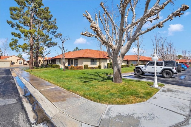 ranch-style home with a front lawn, a tiled roof, a residential view, and stucco siding