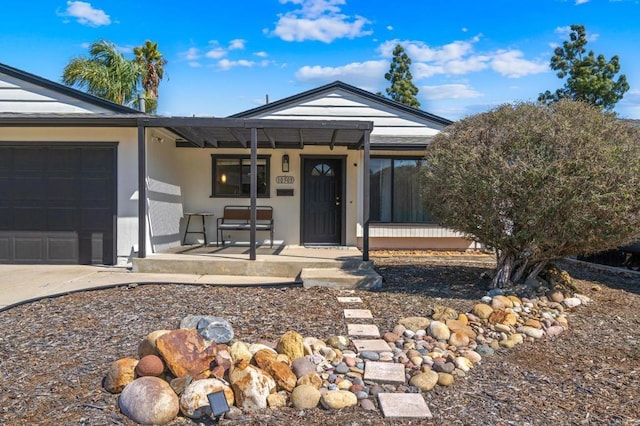 view of front of property with a porch and a garage