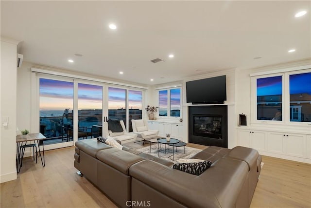 living room featuring recessed lighting, light wood-type flooring, and visible vents