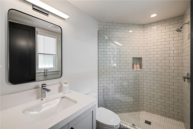 bathroom featuring recessed lighting, vanity, toilet, and a shower stall