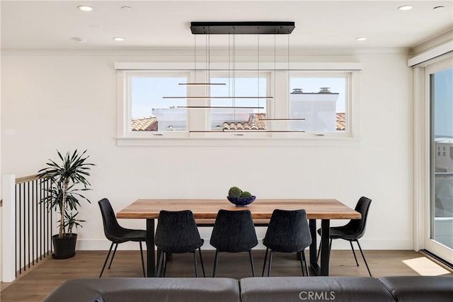 dining area featuring recessed lighting, wood finished floors, and baseboards