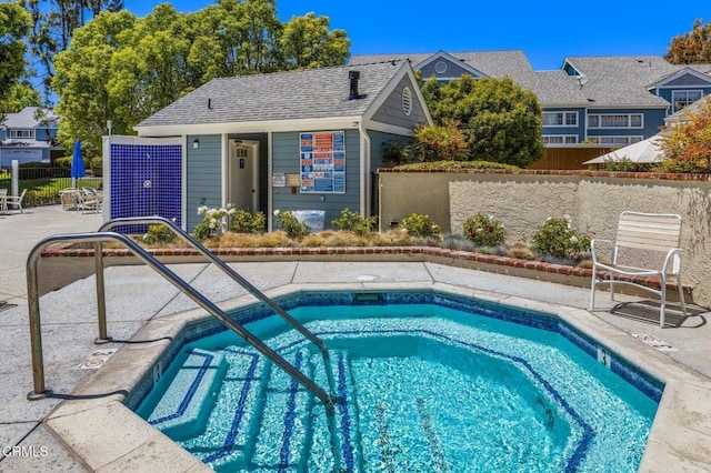 view of swimming pool featuring a patio area, a pool, and fence