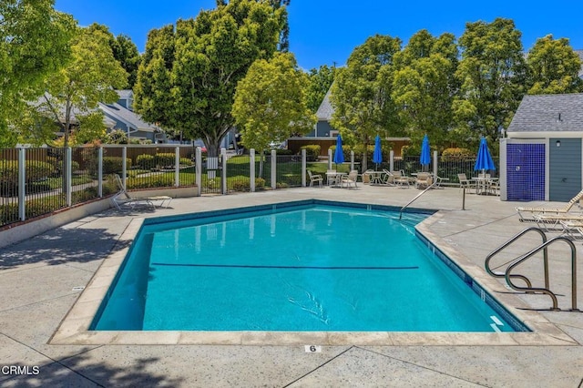 community pool featuring a patio and fence