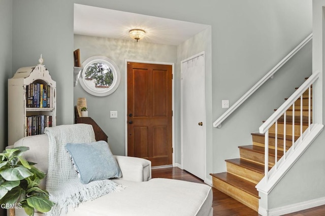 entrance foyer featuring dark wood finished floors and stairway