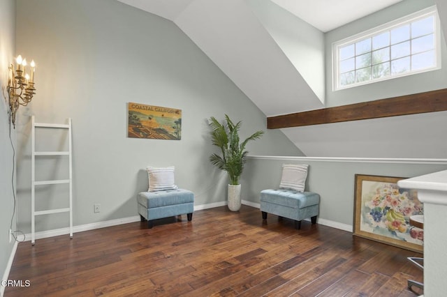 living area featuring vaulted ceiling, hardwood / wood-style flooring, baseboards, and a chandelier