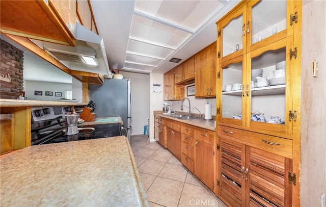 kitchen featuring a sink, electric range oven, light tile patterned flooring, brown cabinetry, and light countertops