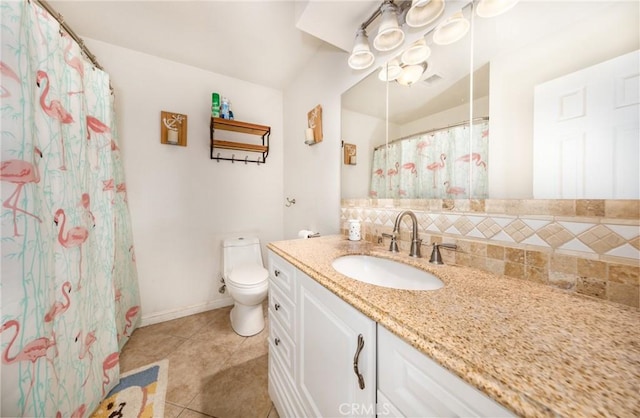 bathroom with vanity, baseboards, tile patterned flooring, toilet, and tasteful backsplash