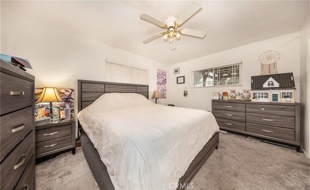 bedroom featuring light colored carpet and a ceiling fan