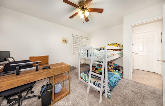 bedroom featuring carpet floors, a ceiling fan, and tile patterned flooring