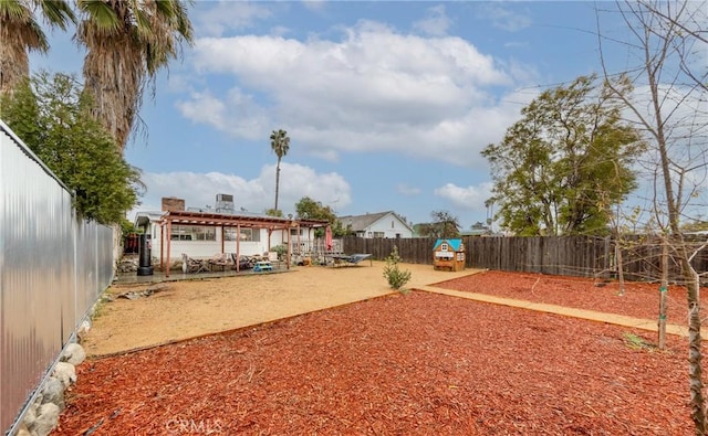 view of yard with a patio area, a pergola, and a fenced backyard