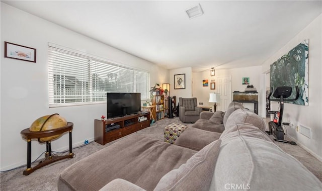 living area featuring visible vents, baseboards, and carpet floors