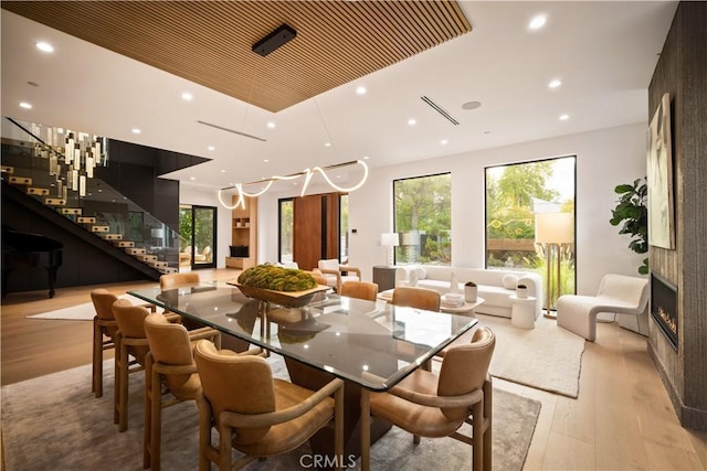 5244 Tampa Ave, Tarzana, CA 91356 - dining room featuring recessed lighting, light wood-style flooring, plenty of natural light, and stairs