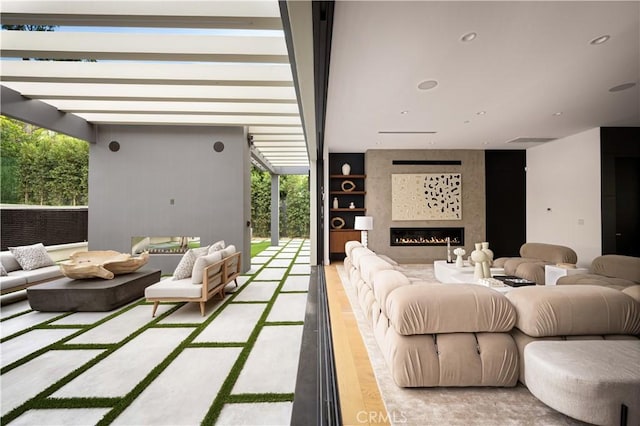 5244 Tampa Ave, Tarzana, CA 91356 - interior space featuring a wall of windows, a large fireplace, wood finished floors, and recessed lighting