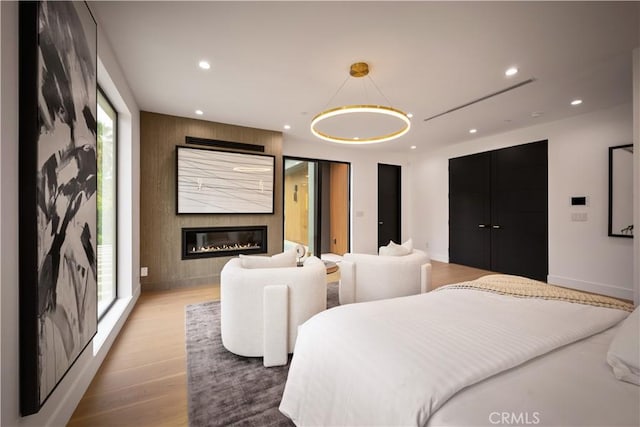 5244 Tampa Ave, Tarzana, CA 91356 - bedroom featuring recessed lighting, baseboards, a large fireplace, and wood finished floors