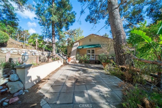 view of front of property featuring french doors and stucco siding