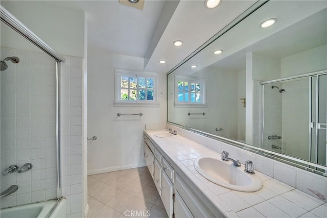 full bathroom featuring a sink, baseboards, double vanity, and tile patterned floors